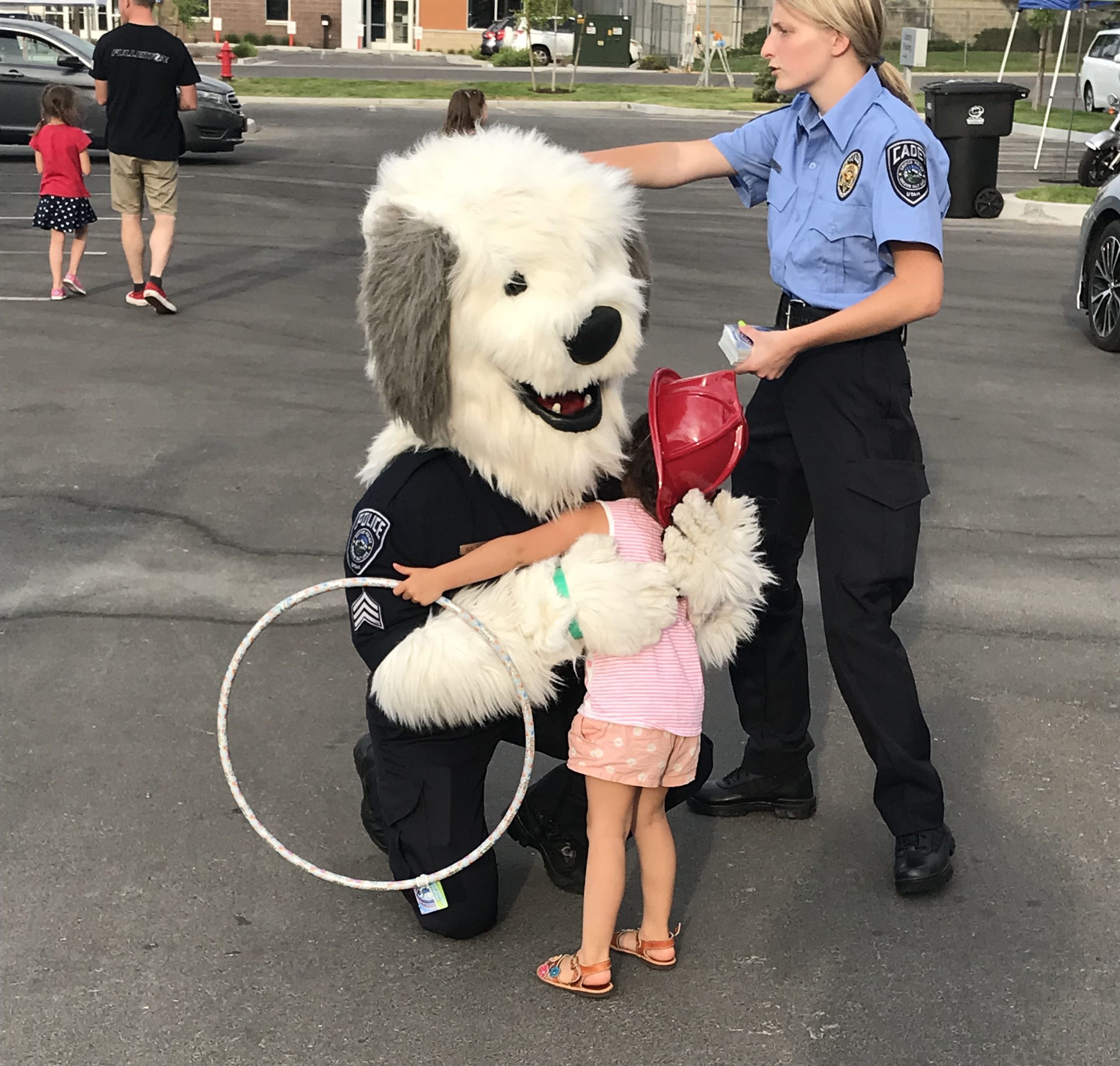 Kearns Hometown Event Mascot Sgt Siren hugged by little girl